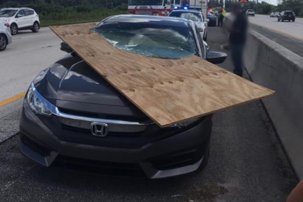 Woman escapes scary accident when plywood slices through windshield