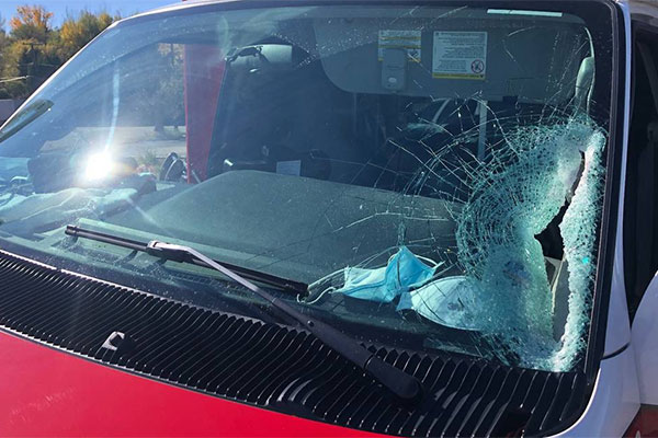 Plywood smashes ambulance windshield nearly striking driver