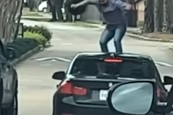 Road rage incident shows man jumping on woman’s windshield